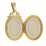 A modern, 9ct yellow gold, sapphire set, four stone, oval locket open