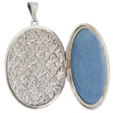A Victorian, silver, oval locket with a floral decoration
