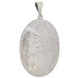 A Victorian, silver, oval locket with a floral decoration