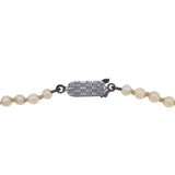 A mid-20th century, single row of graduated cultured pearls on a silver snap