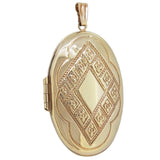 A modern, 9ct yellow gold, engraved oval locket