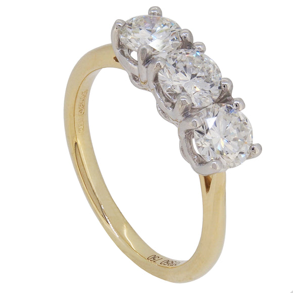 An 18ct yellow gold & platinum setting, diamond set trilogy ring