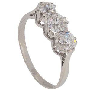 An early 20th century, platinum, old cut diamond set three stone ring
