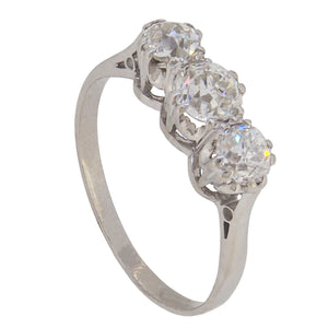 An early 20th century, platinum, old cut diamond set three stone ring