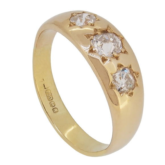 A modern, 18ct yellow gold, old cut diamond gypsy set, three stone ring.