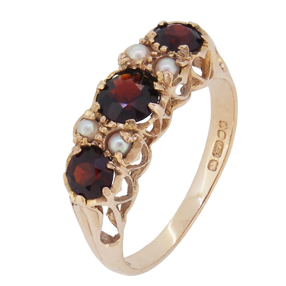 A modern, 9ct yellow gold, garnet & pearl set seven stone ring