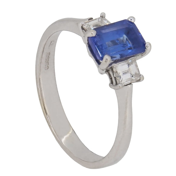 A modern, 18ct white gold, tanzanite & diamond set three stone ring.