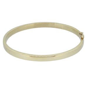 A modern, 9ct yellow gold, solid hinged bangle.