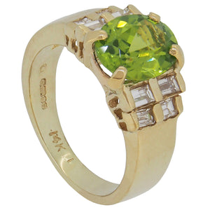 A modern, 14ct yellow gold, peridot &amp; baguette cut diamond set, nine stone ring