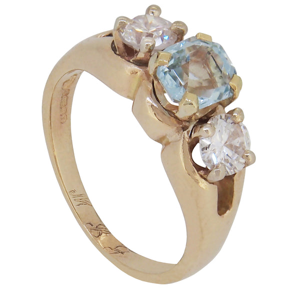 A modern, 14ct yellow gold, aquamarine & diamond set three stone ring