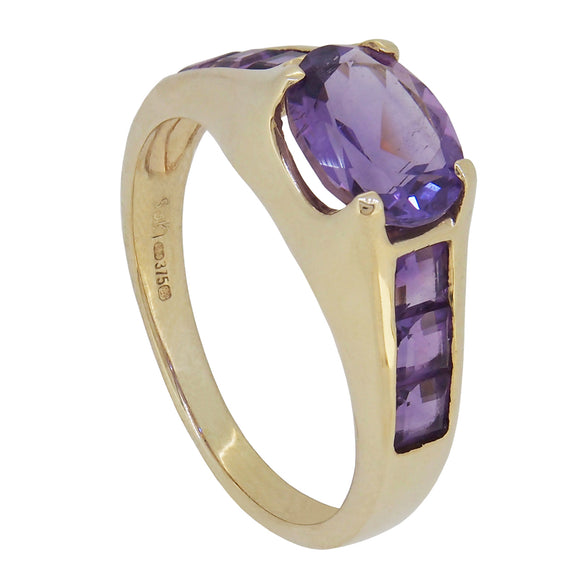 A modern, 9ct yellow gold, amethyst set, seven stone ring