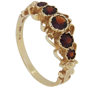 A modern, 9ct yellow gold, garnet set, five stone, half hoop ring.