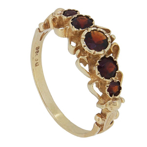 A modern, 9ct yellow gold, garnet set, five stone, half hoop ring