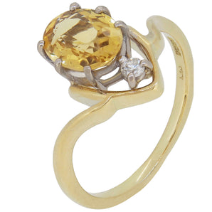 A modern, 18ct yellow gold, yellow beryl & diamond set two stone ring.