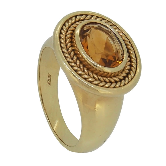 A modern, 18ct yellow gold, citrine set single stone ring with a cord border