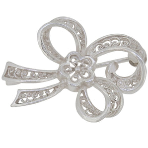 A modern, silver, filigree bow brooch