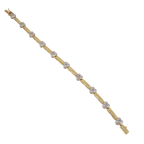 A modern, 18ct yellow & white gold, diamond set inline bracelet