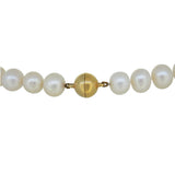 A modern, single row of cultured freshwater pearls on a silver gilt magnetic snap