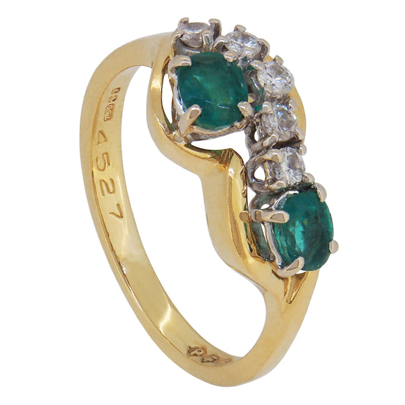 A modern, 18ct yellow gold, emerald & diamond set, seven stone abstract ring