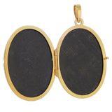 A modern, 9ct yellow gold, oval locket with a floral design