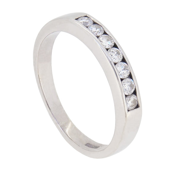 A modern, 9ct white gold, diamond set, channel set, seven stone, half eternity ring