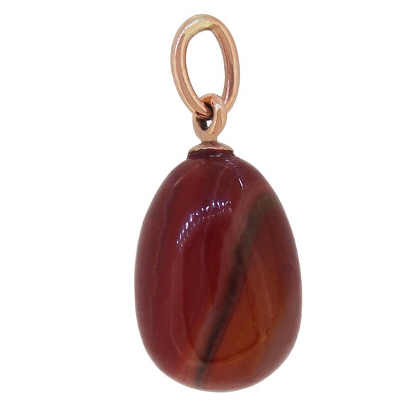An early 20th century, 9ct rose gold, striped brown agate set pendant.