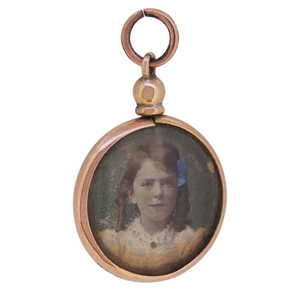 An Edwardian, 9ct rose gold, open, double sided photograph locket with two photos of a young lady and an older lady.