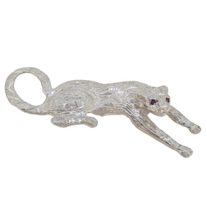 A mid-20th century, silver, garnet set panther brooch.