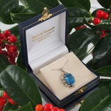 A modern, 9ct white gold, London blue topaz set pendant & chain.