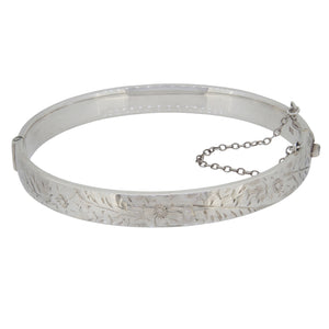 A modern, silver, hinged, half engraved bangle