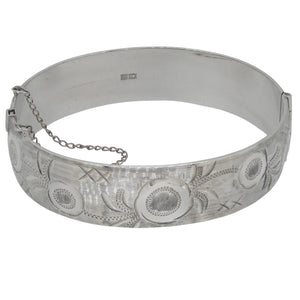 A mid-20th century, silver, half engraved bangle.