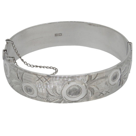 A mid-20th century, silver, half engraved bangle.