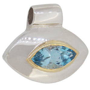 A modern, silver & silver gilt, blue topaz set pendant.