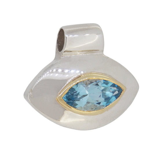 A modern, silver, blue topaz set pendant