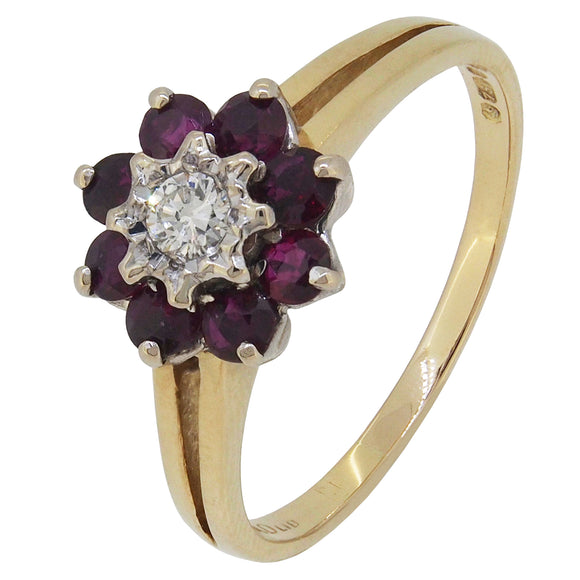 A modern, 18ct yellow gold, ruby & diamond set, nine stone, reverse cluster ring.