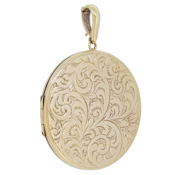 A 9ct yellow gold, large circular, engraved locket.