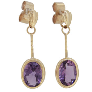 A pair of modern, 9ct yellow gold, amethyst set drop earrings.
