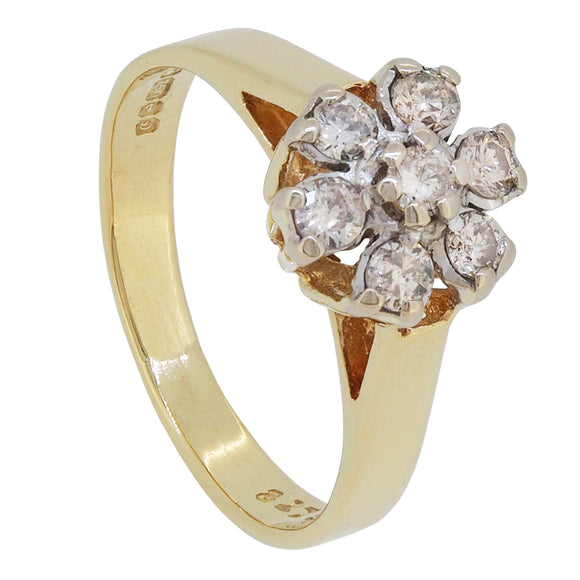 A modern, 18ct yellow gold, diamond set, seven stone cluster ring.