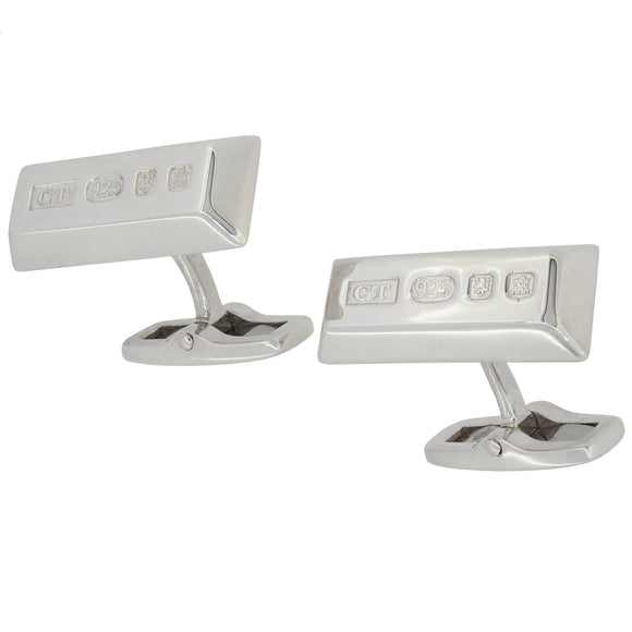 A pair of modern, silver, oblong, ingot, bar link cufflinks with featured hallmarks.