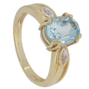 A modern, 9ct yellow gold, blue topaz &amp; diamond set ring.