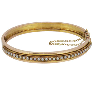 A Victorian, 18ct yellow gold, French, seed pearl set hinged bangle.