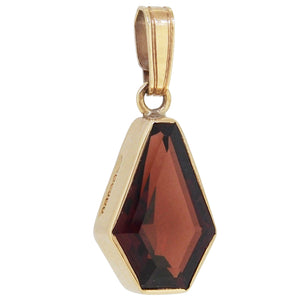 A modern, 9ct yellow gold, garnet set pendant.