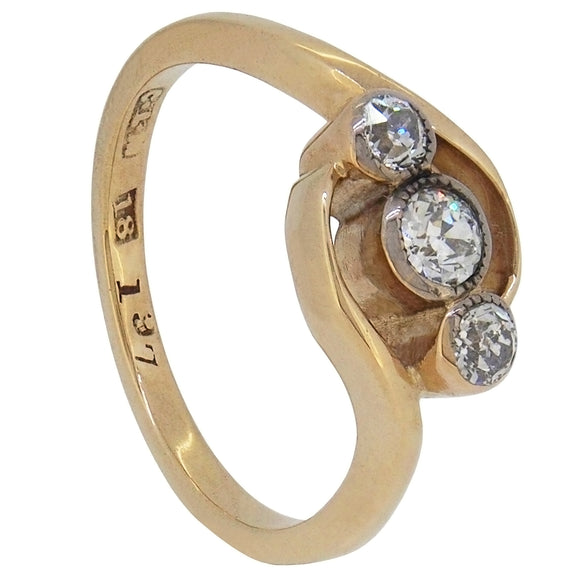 An early 20th century, 18ct yellow gold, diamond set three stone ring.