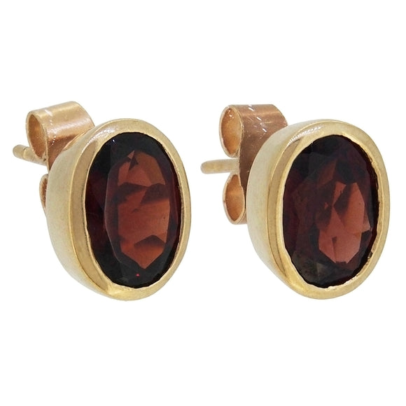 A pair of modern, 9ct yellow gold, garnet set stud earrings.