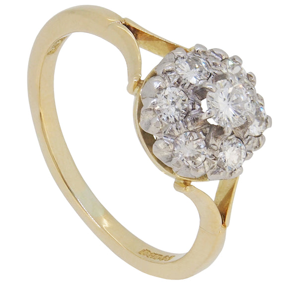 A modern, 18ct yellow gold, diamond set, seven stone cluster ring.