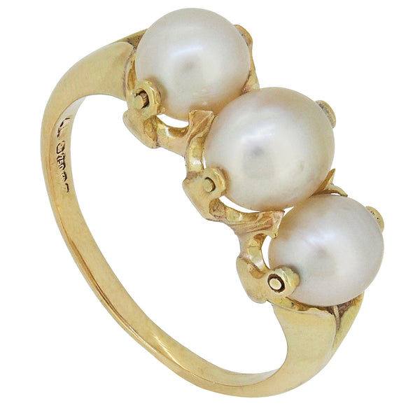 A modern, 18ct yellow gold, pearl set three stone ring.