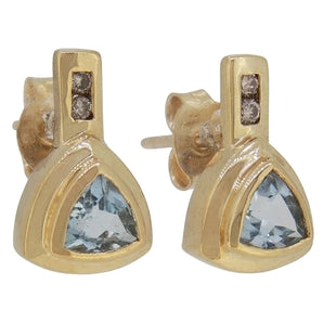 A pair of modern, 9ct yellow gold, blue topaz & diamond set stud earrings.
