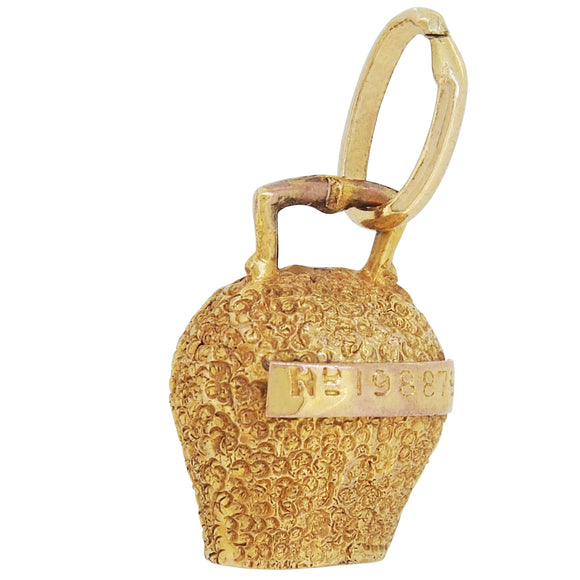 A mid-20th century, 9ct yellow gold cowbell charm.