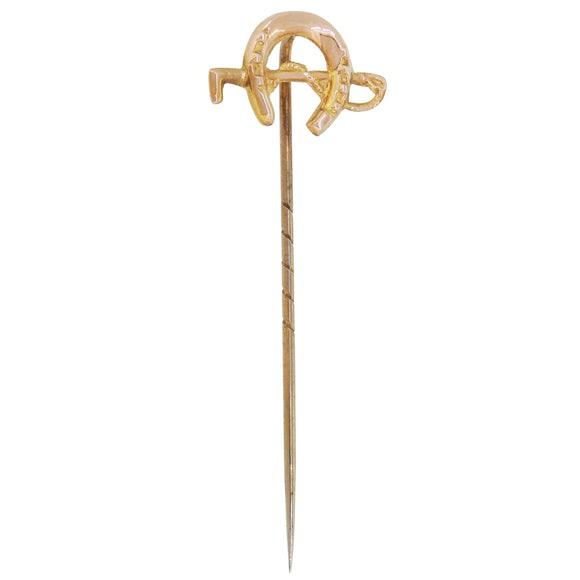 An early 20th century, 9ct yellow gold, horseshoe & riding crop stick pin.