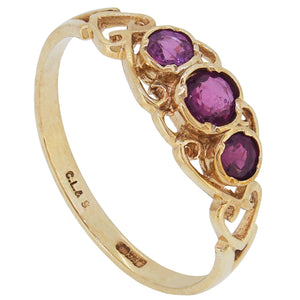 A 9ct yellow gold, ruby set, three stone ring